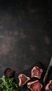 Top view of raw lamb chops and fresh mutton cutlets on dark background with ample copy space Royalty Free Stock Photo