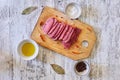 Top view of raw meat cuts with herbs and spices on the cutting b