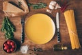 Top view of raw pasta, fresh ingredients and plate with knife and fork Royalty Free Stock Photo