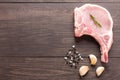 Top view raw pork chop steak and garlic, pepper, salt on wooden Royalty Free Stock Photo