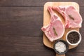 Top view raw pork chop steak and garlic, pepper on wooden backgr Royalty Free Stock Photo