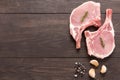 Top view raw pork chop steak and garlic, pepper on wooden backgr Royalty Free Stock Photo