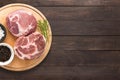 Top view raw pork chop steak and garlic, pepper on wooden background. Copy space for text Royalty Free Stock Photo