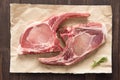 Top view raw pork chop steak on paper on wooden background Royalty Free Stock Photo