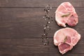 Top view raw pork chop steak and salt, pepper on wooden backgrou Royalty Free Stock Photo