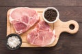 Top view raw pork chop steak on wooden background Royalty Free Stock Photo