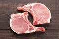 Top view raw pork chop steak on wooden background Royalty Free Stock Photo