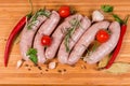 Top view raw pork sausages among spices on cutting board Royalty Free Stock Photo