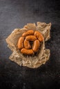 Top of view raw small cocktail sausages on cutting board