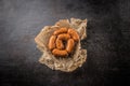 Top of view raw small cocktail sausages on cutting board