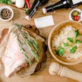 Top view. Raw turkey on a wooden cutting board preparing for roasting with rosemary, stewed cabbage decorated parsley in Royalty Free Stock Photo