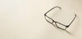 Top view of reading glasses on a cream color table. Empty space for text Royalty Free Stock Photo