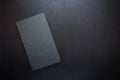 Top view on rectangle black slate plate on rustic dark background. Copy space. Toned Royalty Free Stock Photo