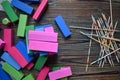 Top view of rectangular colorful wooden blocks and Mikado pick-up-sticks on the wooden table Royalty Free Stock Photo