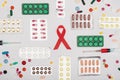 Aids ribbon with pills and syringes Royalty Free Stock Photo