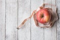 Top view of Red apple with measure tape on white wooden table. Royalty Free Stock Photo