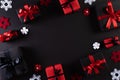 Top view of red and black christmas boxes on black background with copy space for text. black Friday composition Royalty Free Stock Photo