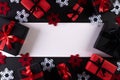 Top view of red and black christmas boxes on black background with copy space for text. black Friday composition Royalty Free Stock Photo