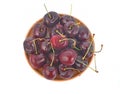 Top view of Red cherry plum in wooden plate isolated on white background Royalty Free Stock Photo