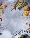 Top view of kitchen table with chili pepper, asparagus, salad pepper, corkscrew, mushrooms, garlic on a gray background. Royalty Free Stock Photo