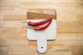 Top view of red chilli on wooden cutting board. Wooden and marble stone texture cutting board design Royalty Free Stock Photo
