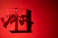 Top view of red christmas boxes with red ribbon on red background with copy space for text. black Friday and Boxing Day Royalty Free Stock Photo