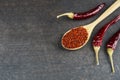 Top view red dried crushed hot chili peppers and chili flakes or powder in wooden spoon and bowl Royalty Free Stock Photo