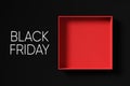 Top view of a red empty gift box on black background with the word black Friday Royalty Free Stock Photo