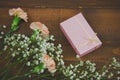 gift box and flowers on a brown wooden boards background