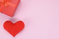 Top view of red gift box and knitted heart on pink background Royalty Free Stock Photo