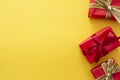 Top view of red gift boxes with ribbon over colorful yellow background. Valentine's day, Christmas or birthday concept Royalty Free Stock Photo