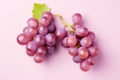 Top view of red grapes on pastel pink background