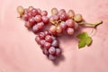 Top view of red grapes on pastel pink background