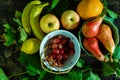 Top view of the red grapes and pears in the bowl with other fruits on the wooden surface Royalty Free Stock Photo