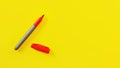 Top view on red marker, cap opened, on yellow board, copyspace for your text on right side Royalty Free Stock Photo