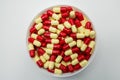 Top view of red, pale yellow, capsule pills in plastic container Royalty Free Stock Photo