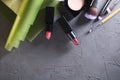 Top view of cosmetic products.Lipsticks, blush, professional brushes on the dark grey surface.Empty space for text Royalty Free Stock Photo