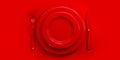 Top view of red plate, fork, knife and spoon on red table