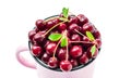 Top view of red ripe cherry berries with sprigs and leaves in a pink mug isolated on white background. Sweet tasty fruits Royalty Free Stock Photo