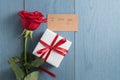 Top view of red rose on blue wood table with i love you paper card and gift Royalty Free Stock Photo