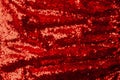 top view of red textile with shiny sequins as