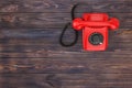 Top View of Red Vintage Styled Rotary Phone on a Wooden Table. 3d Rendering Royalty Free Stock Photo