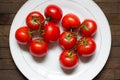 Top view of red washed tomatoes on big white plate Royalty Free Stock Photo