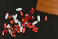 Top view of red and white role playing RPG dice of different shape on black background