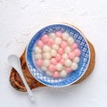 Top view of red and white tangyuan in blue bowl on white background for Winter solstice