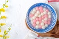 Top view of red and white tangyuan in blue bowl on white background for Winter solstice