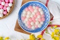 Top view of red and white tangyuan in blue bowl on white background for Winter solstice