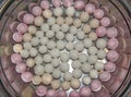 Top view of red and white tangyuan tang yuan, glutinous rice dumpling balls in steel bowl.