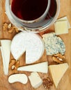 Top view of red wine glass and assortment cheeses Royalty Free Stock Photo