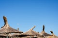 Reed umbrella roof against blue clear sky  on  summer time   at beach Royalty Free Stock Photo